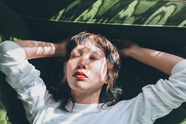young gen-z female relaxing at home - hairstyle stockfoto's en -beelden