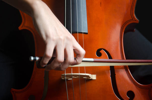 young girl playing cello, close-up. - concert stock pictures, royalty-free photos & images
