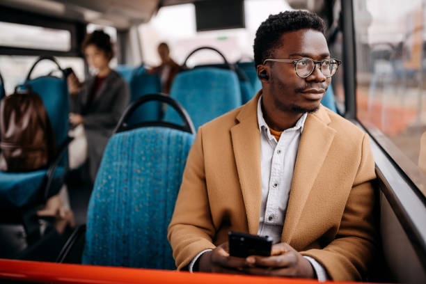 young handsome businessman in public bus - travel stock pictures, royalty-free photos & images