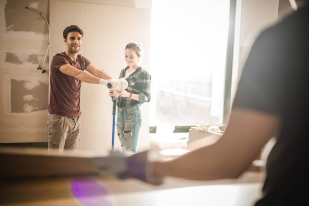 young happy couple renovating their apartment. - home decoration stock pictures, royalty-free photos & images