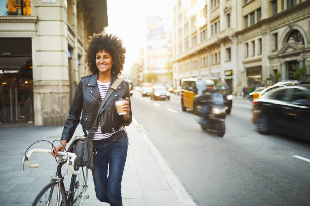 young hipster woman in the streets of barcelona commuting. - junk food stock pictures, royalty-free photos & images