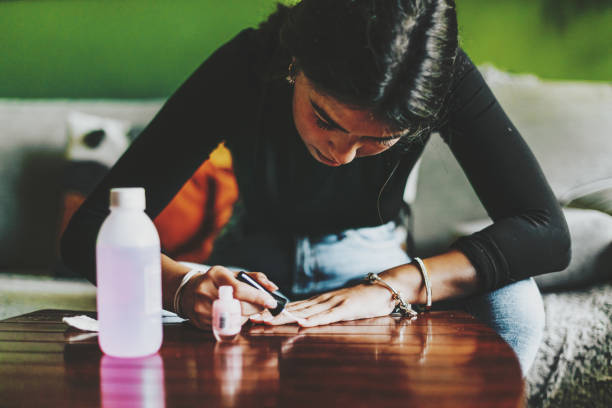 young latina f woman with long, slender fingers, paints her nails at home - nails art stock pictures, royalty-free photos & images