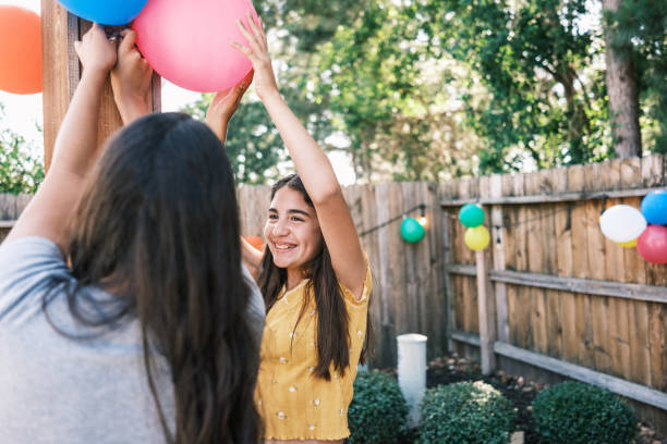 young latino women decorating at the backyard party - garden decoration stock pictures, royalty-free photos & images