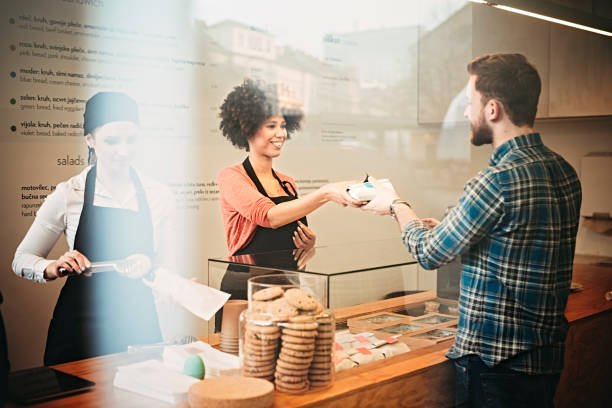 young man buying food snack bar - junk food stock pictures, royalty-free photos & images