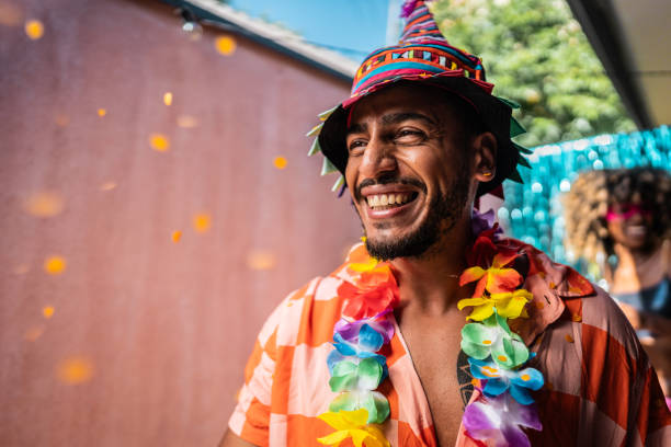 young man enjoying carnival at home - garden decoration stock pictures, royalty-free photos & images