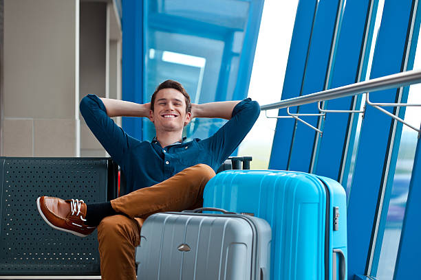 young man in an airport lounge - travel stock pictures, royalty-free photos & images
