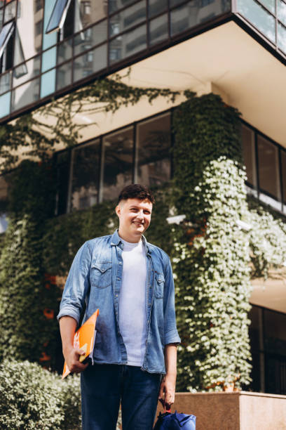 young man near building with living walls. - garden decoration stock pictures, royalty-free photos & images