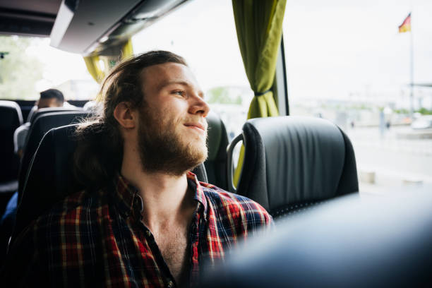 young man relaxing during a bus trip - travel stock pictures, royalty-free photos & images