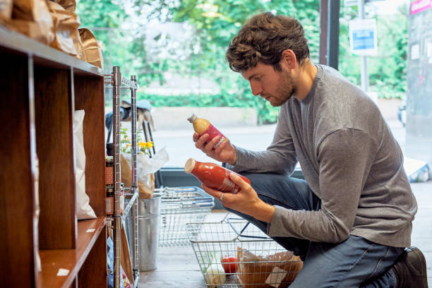 young man shopping in food store. - food stock pictures, royalty-free photos & images