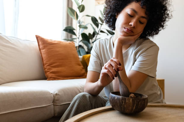 young multiracial woman eating breakfast feeling very bored and unmotivated. lack of appetite. copy space. - food stock pictures, royalty-free photos & images