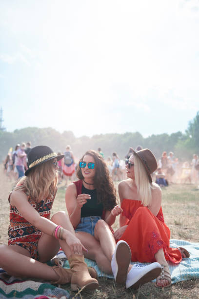 young people sitting on blanket at music festival - concert stock pictures, royalty-free photos & images
