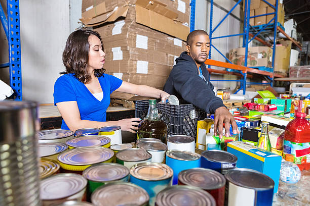 young people volunteering to sort donations for charity food drive - food stock pictures, royalty-free photos & images