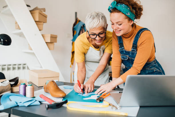 young shoemaker learning to work from the older colleague - fashion stock pictures, royalty-free photos & images