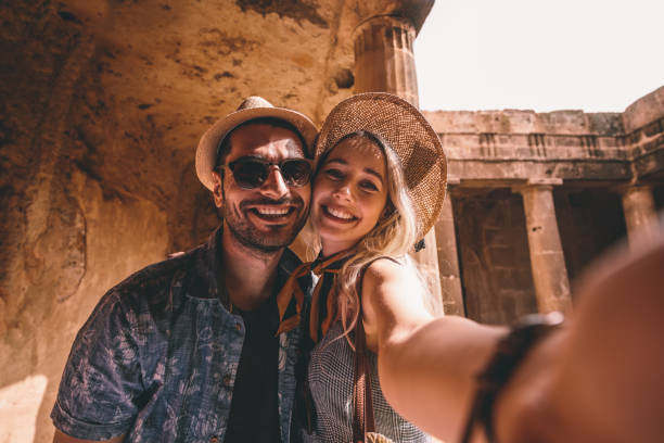 young tourists couple taking selfies at ancient monument in italy - travel stock pictures, royalty-free photos & images