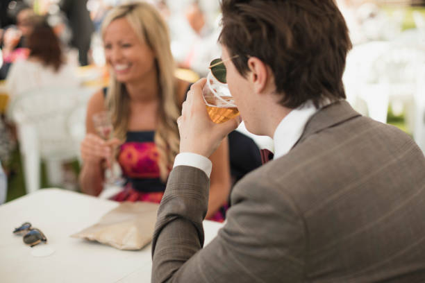 young trendy male drinking in a marquee - home decoration stock pictures, royalty-free photos & images
