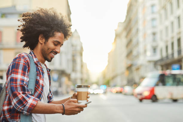 young trendy man in barcelona. - junk food stock pictures, royalty-free photos & images