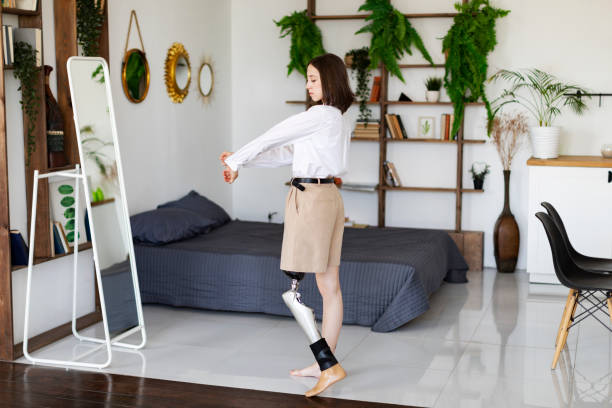 young woman amputee with prosthesis trying on new clothes at home - fashion stock pictures, royalty-free photos & images
