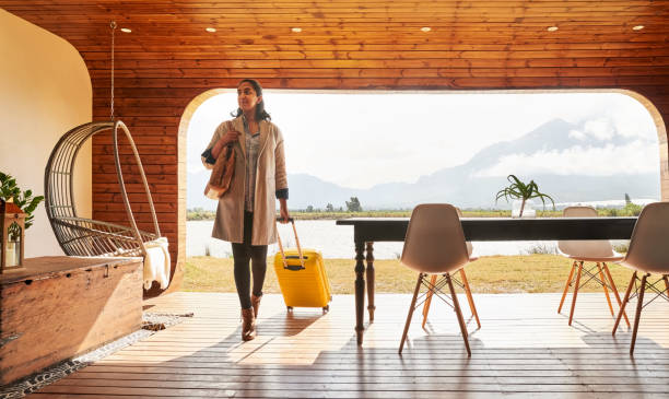 young woman arriving at a holiday home resort for her vacation - travel stock pictures, royalty-free photos & images