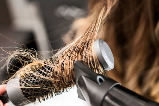 young woman at a hair salon ,hairdresser using hairdryer - hairstyle stock pictures, royalty-free photos & images