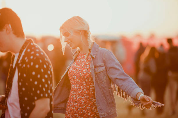 young woman dancing at a music festival - concert stock pictures, royalty-free photos & images