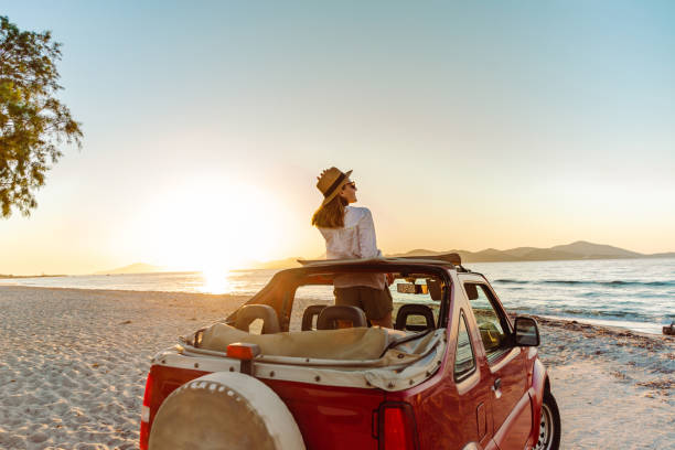young woman enjoying the seaside road trip - travel stockfoto's en -beelden