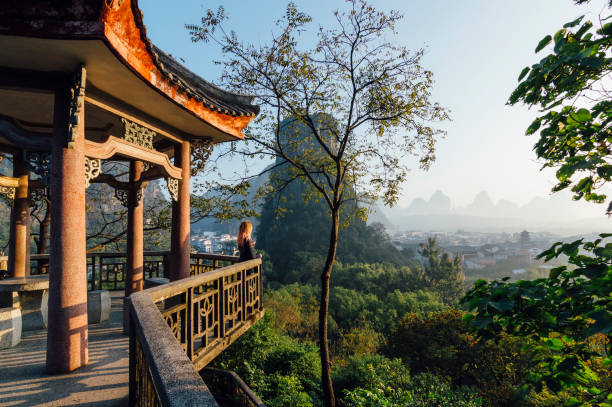 young woman enjoys view over yangshuo, karst mountains - travel stock pictures, royalty-free photos & images