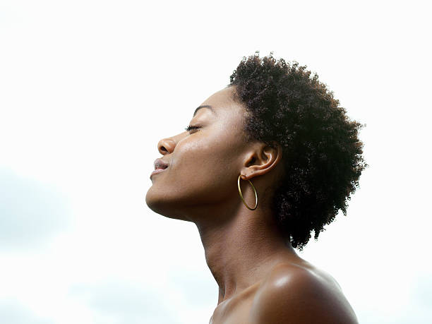 young woman, eyes closed, low angle view, profile - hairstyle stockfoto's en -beelden