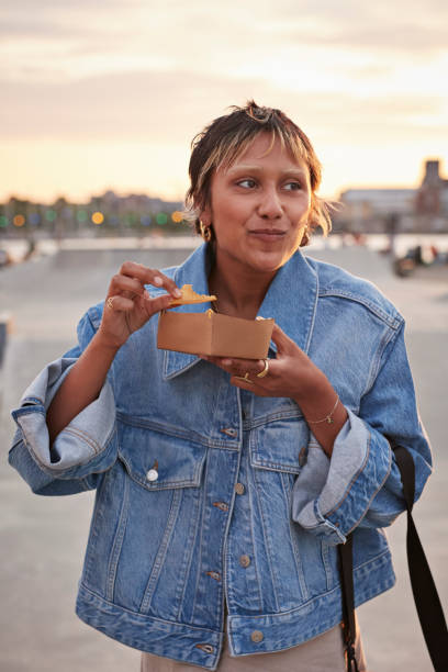 young woman having food on weekend - junk food stock pictures, royalty-free photos & images