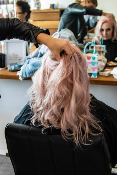 young woman having her hair done - hairstyle stock pictures, royalty-free photos & images