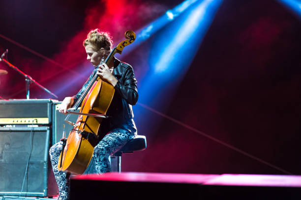 young woman playing cello on the concert - concert stock pictures, royalty-free photos & images