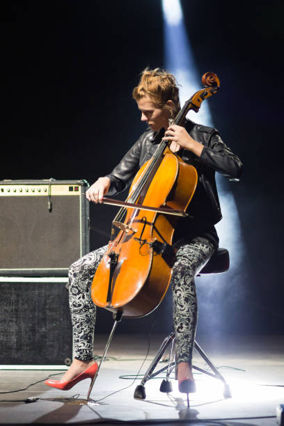 young woman playing cello on the stage - concert stock pictures, royalty-free photos & images