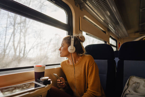 young woman riding a train - travel stock pictures, royalty-free photos & images