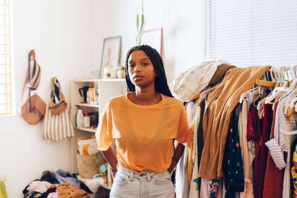 young woman standing in room - fashion stock pictures, royalty-free photos & images