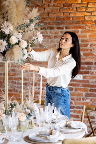 young woman wedding planner enchants the wedding ceremony with floral delights. - home decoration stockfoto's en -beelden