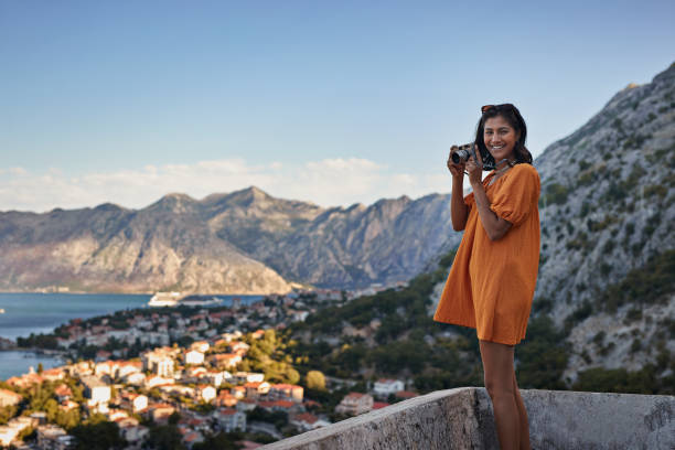young woman with camera against mountains - travel stock pictures, royalty-free photos & images
