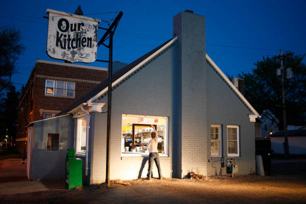 young women holding a picture frame at a diner. - home decoration stock pictures, royalty-free photos & images