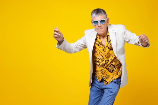 youthful old man in the sixties having fun and dancing - fashion stock pictures, royalty-free photos & images