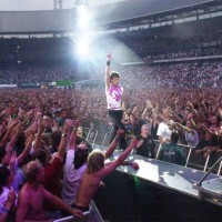 11th AUGUST: Mick Jagger from The Rolling Stones performs live on stage walking down gantry in arena/stadium with crowds/audience surrounding him...
