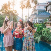 3 asian chinese female playing with confetti at the poolside of the backyard of the house during birthday celebration event in the evening - garden decoration stock pictures, royalty-free photos & images