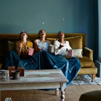 3 friends catching popcorn with the mouth - food stock pictures, royalty-free photos & images