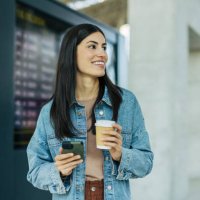 a adult cheerful woman at the airport or train station. - junk food stock pictures, royalty-free photos & images