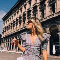 a beautiful businesswoman with sunglasses looking away while standing in the street - fashion stock pictures, royalty-free photos & images