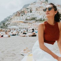 a beautiful woman enjoys lounging on a beach in positano, italy - travel stock pictures, royalty-free photos & images