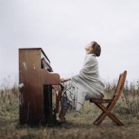 a beautiful woman is playing the piano with pleasure in a field in autumn - concert stock pictures, royalty-free photos & images