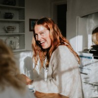 a beautiful young woman laughs in a sunny kitchen - food stock pictures, royalty-free photos & images