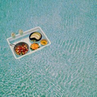 a breakfast tray floats across a pool (wide) - food stock pictures, royalty-free photos & images