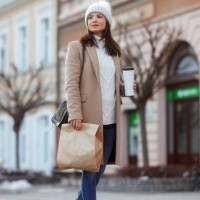 a caucasian woman strolls along a city street - fashion stock pictures, royalty-free photos & images