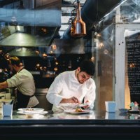 a chef is cooking in his restaurant's kitchen - food stock pictures, royalty-free photos & images