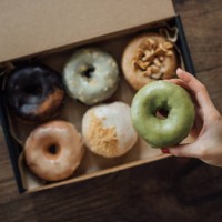 a choice of various delicious crafted donuts from a takeaway box - junk food stock pictures, royalty-free photos & images