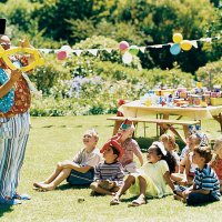 a clown amuses a medium group of children at a birthday party - garden decoration stock pictures, royalty-free photos & images